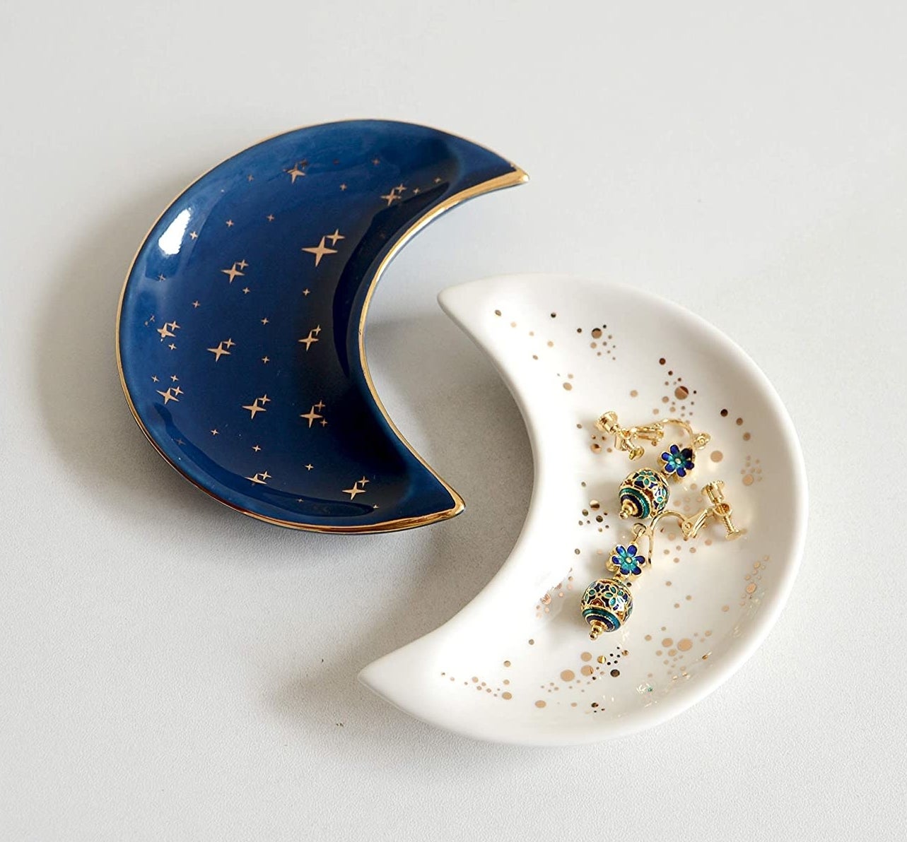a pair of crescent moon-shaped trinket dishes