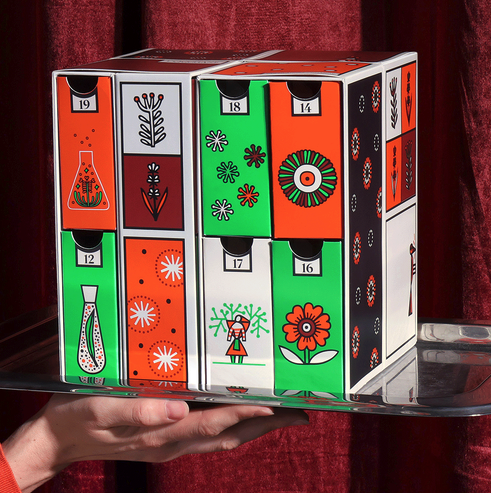 a boxy advent calender with drawers in a red white and green design on it