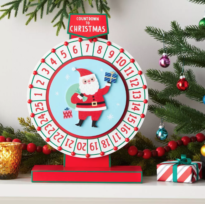 a wooden countdown to christmas advent calendar wheel with santa in the middle