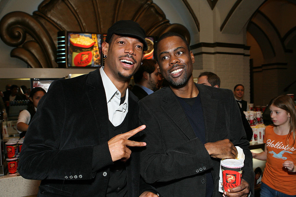 Marlon and Chris side-by-side at a movie theater event