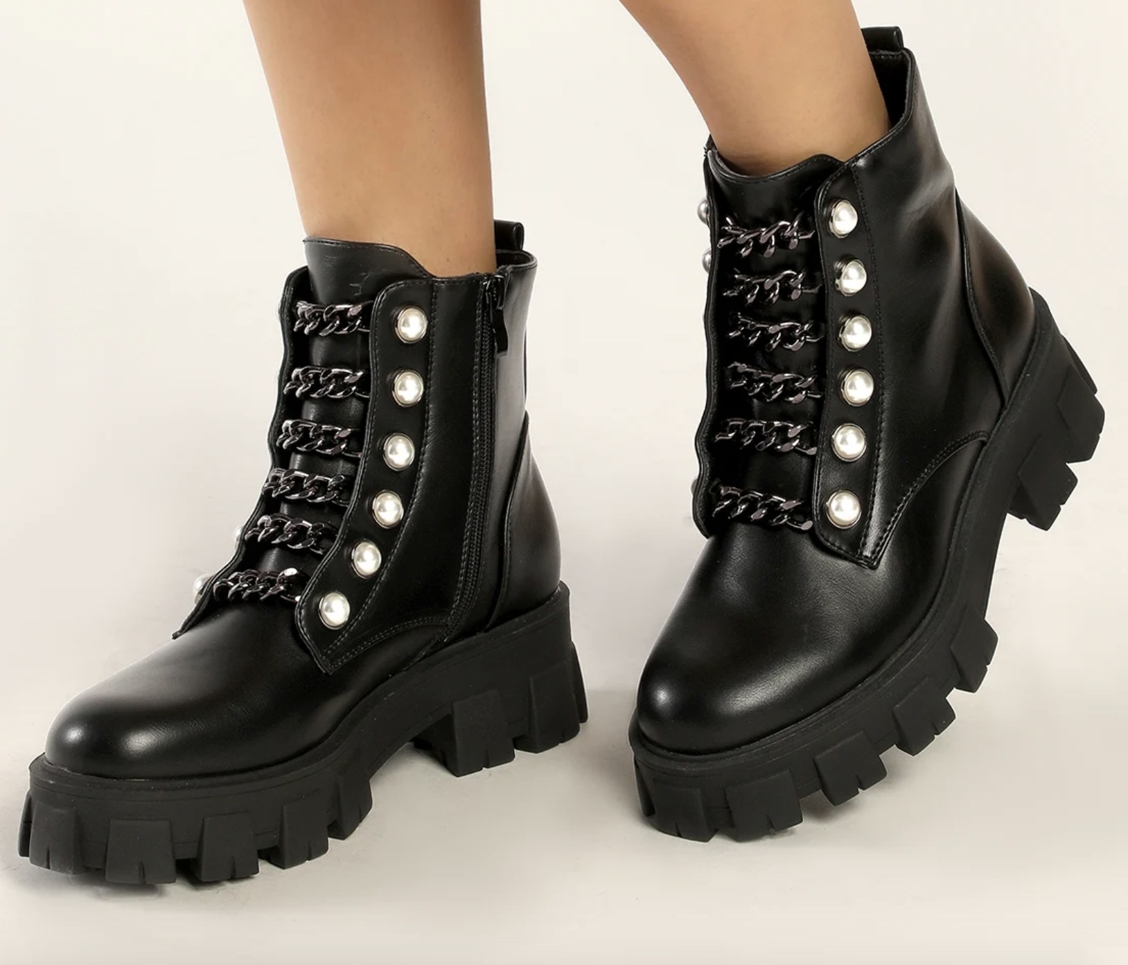 The black booties have black chains and shiny pearls