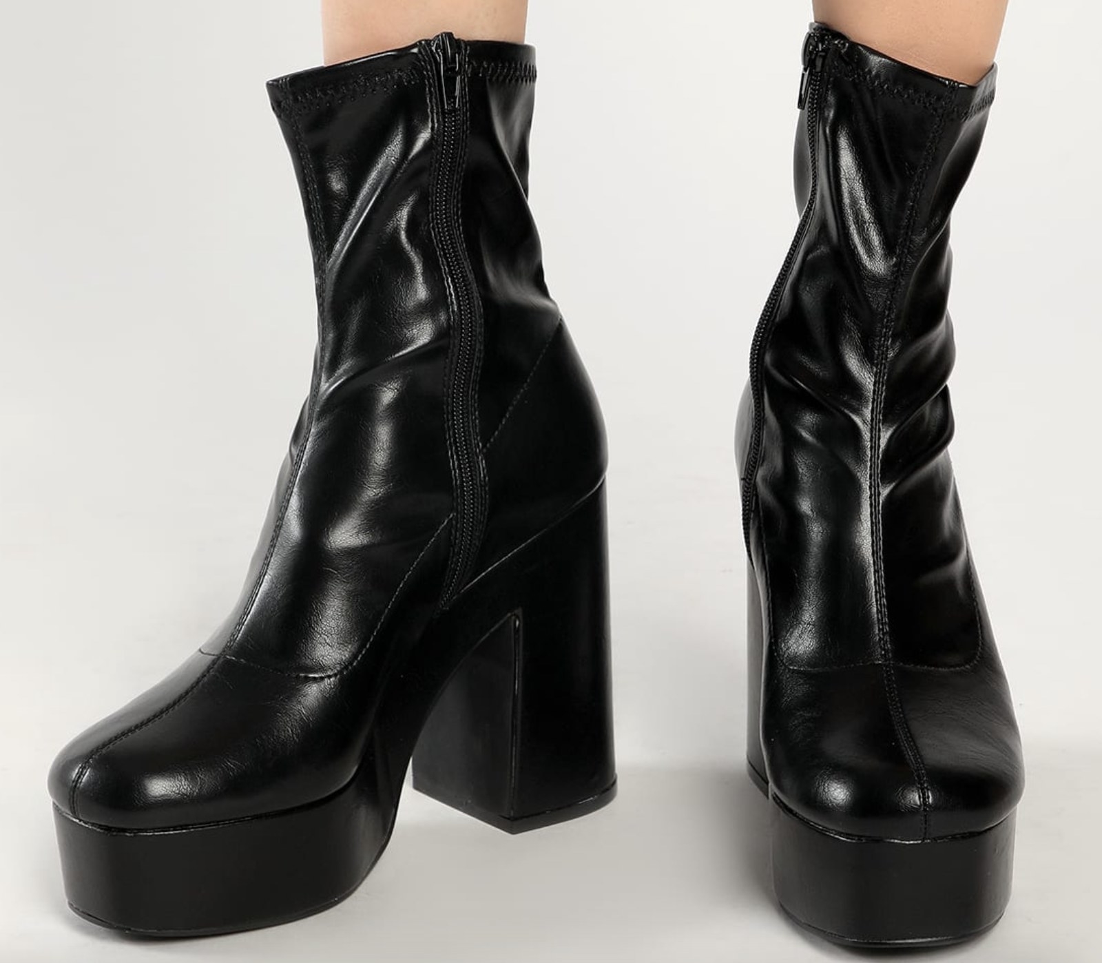The shimmery black leather boots are shown in a close-up shot