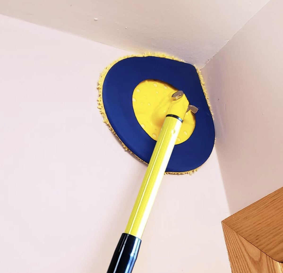 A wall mop cleaning the corner of a wall