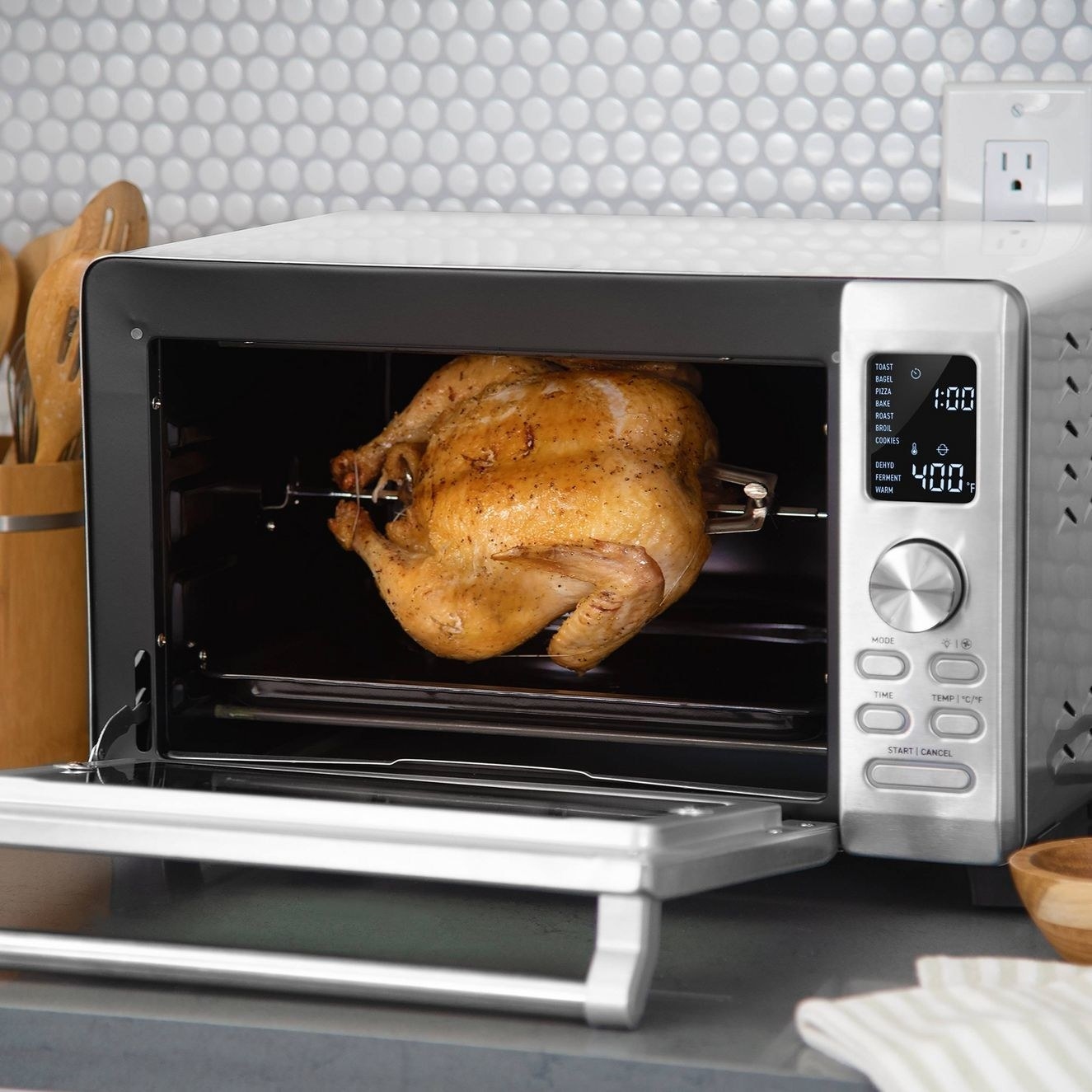 The convection oven with a chicken in it