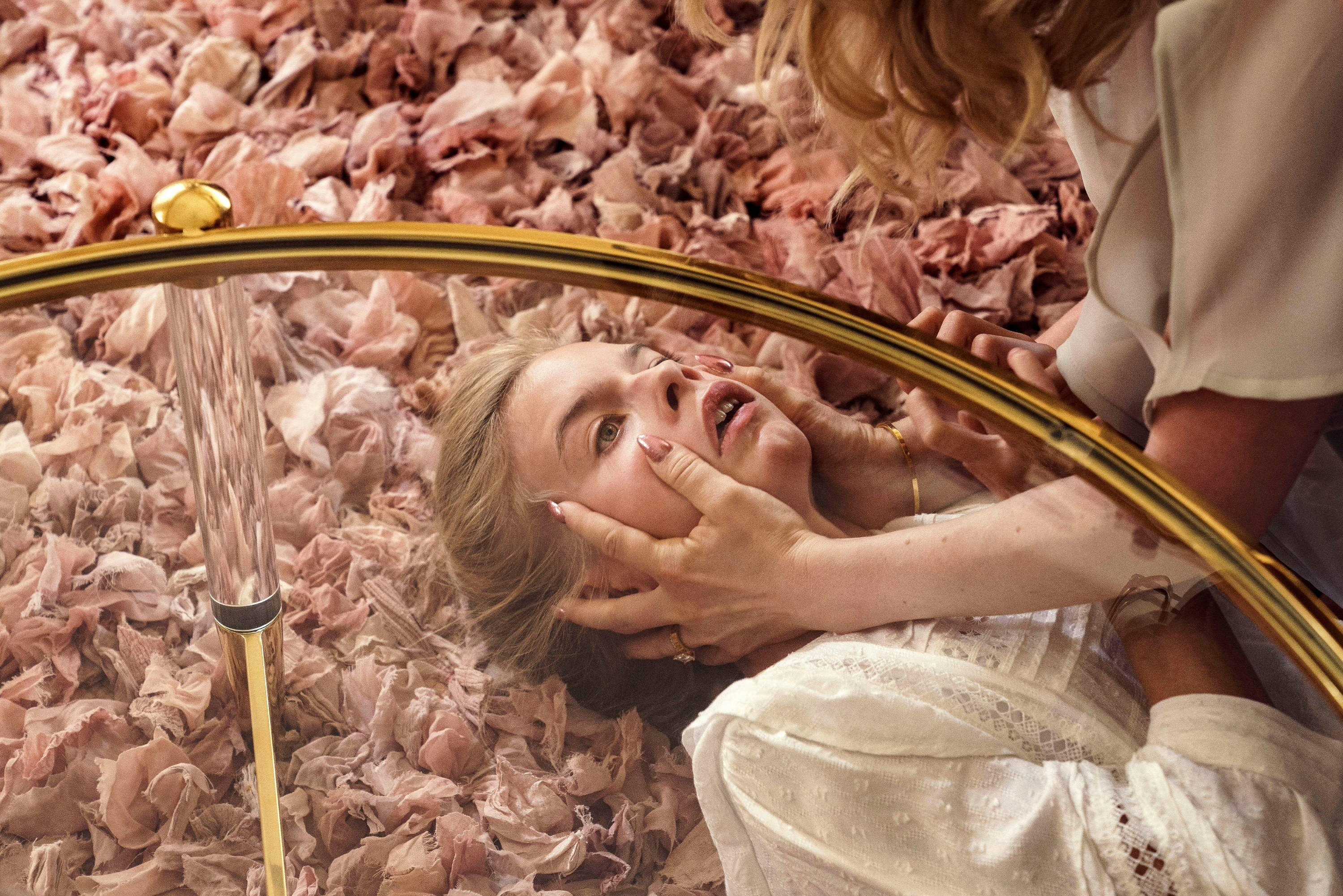 A young woman is attacked by a monstrous doppelganger on a pink carpet in “Hatching”