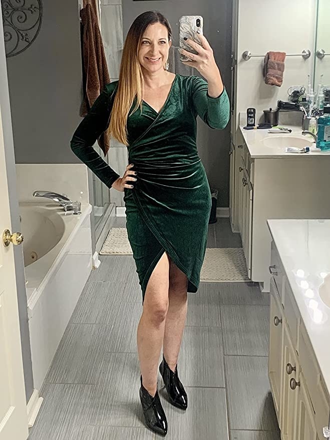 A person wearing the dress taking a photo of themselves in their bathroom before they go out