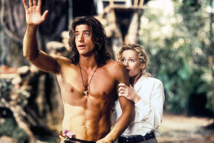A shirtless Fraser waving in &quot;George of the Jungle&quot; while a frightened woman clutches his arm