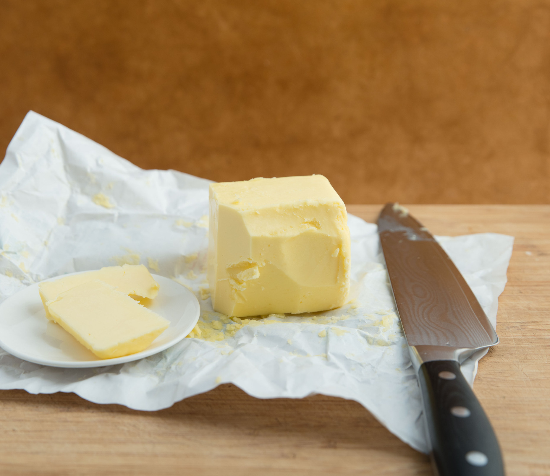 A stick of butter on a counter