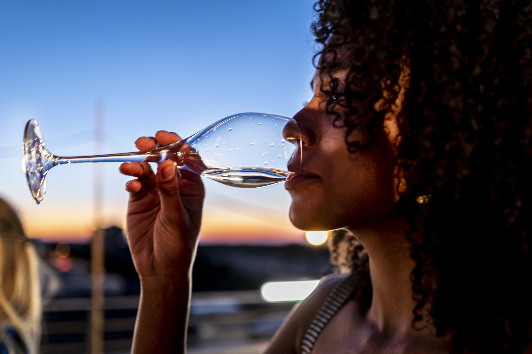 A woman drinking from a wine glass