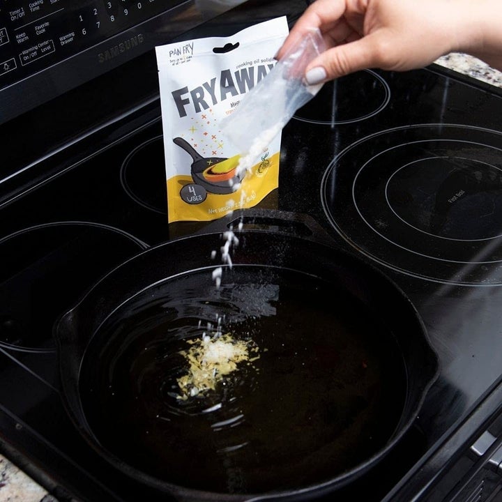 someone dusting the packet into a pan of hot oil