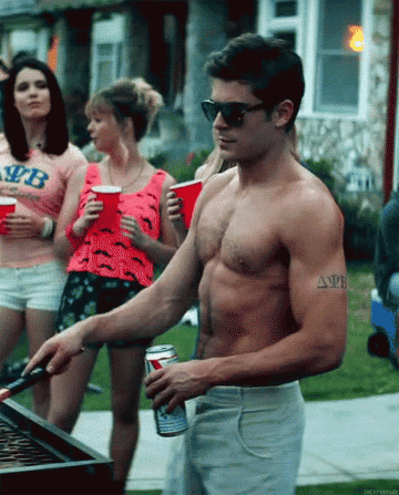 A man grilling and women holding Solo cups