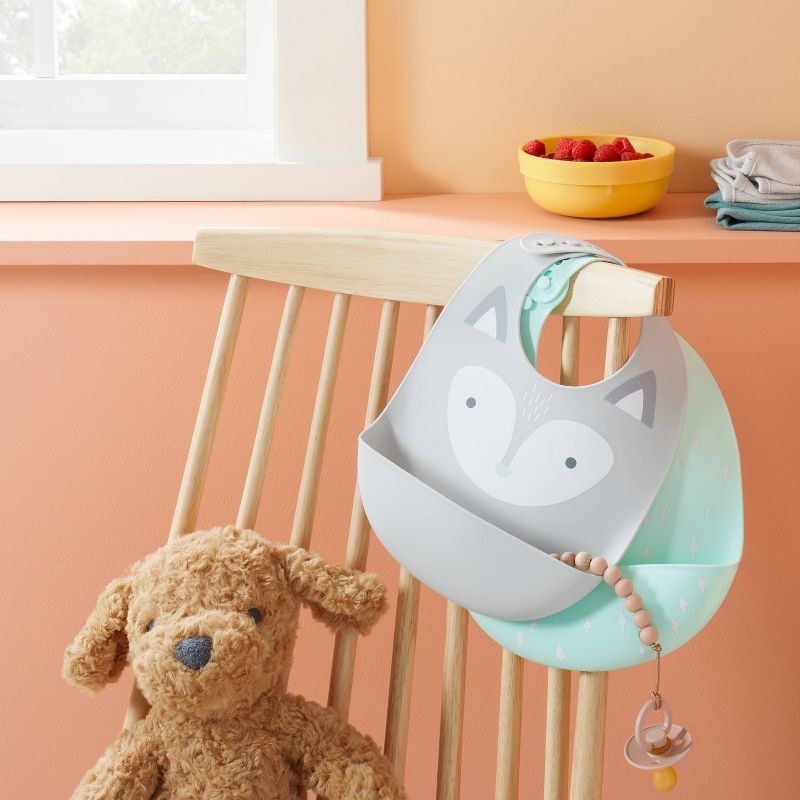 Bibs hanging on wooden chair