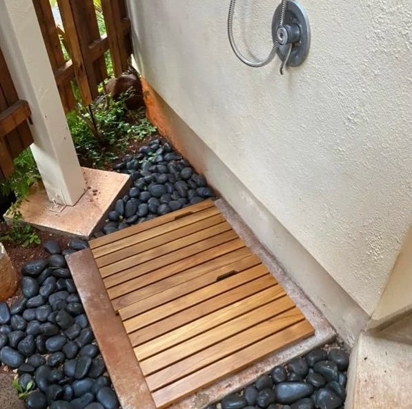 Two teak wood bathroom mats placed next to each other