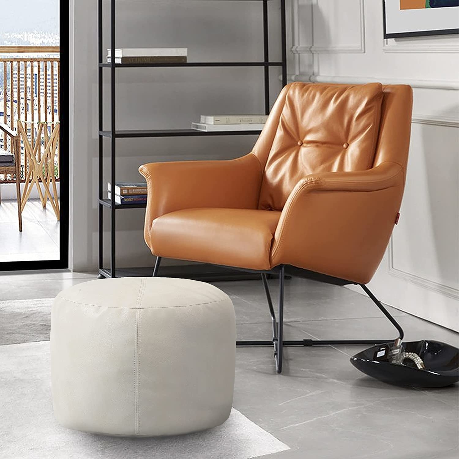 the pouf next to a leather seat