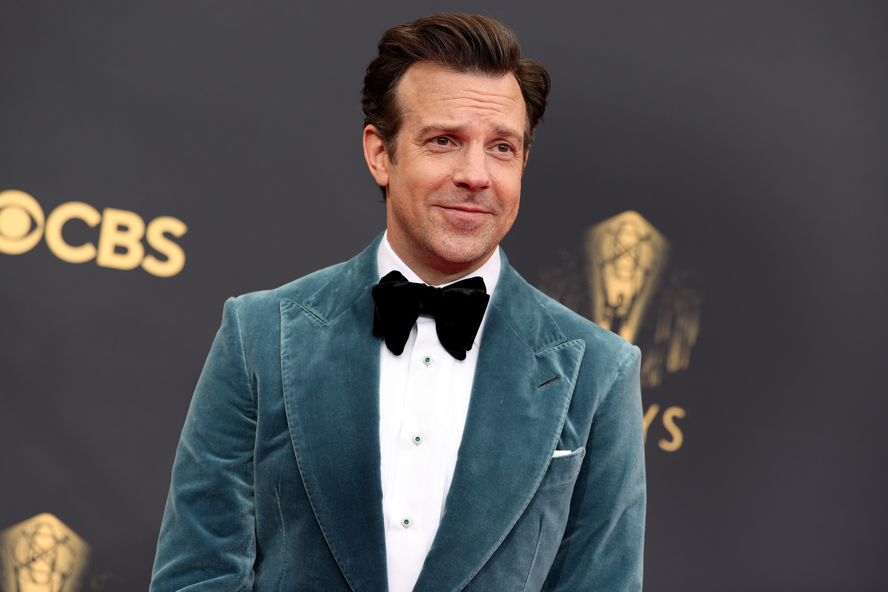 A closeup of Jason at the Emmys wearing a velvet tuxedo and bowtie