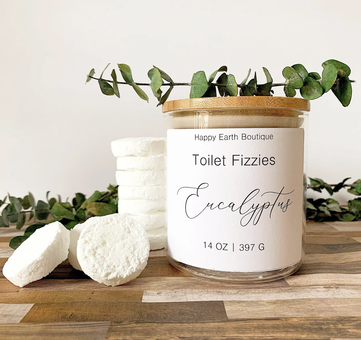 A jar of toilet fizzies with some beside the jar