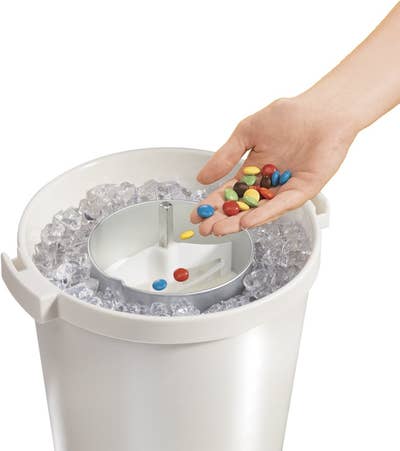 hand adding candy mix-ins to the ice cream maker
