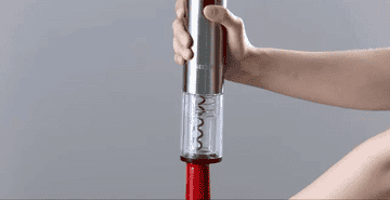 a gif of a hand using the wine opener