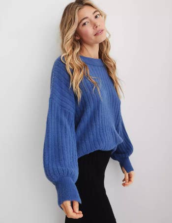 a model in a cobalt blue sweater