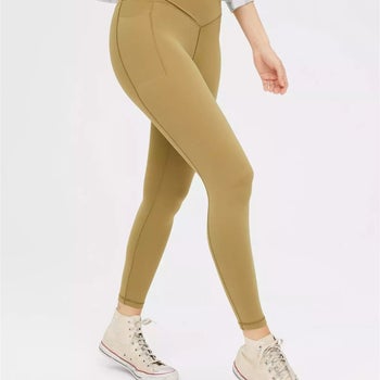 model wearing the olive moss leggings with Converse high top sneakers