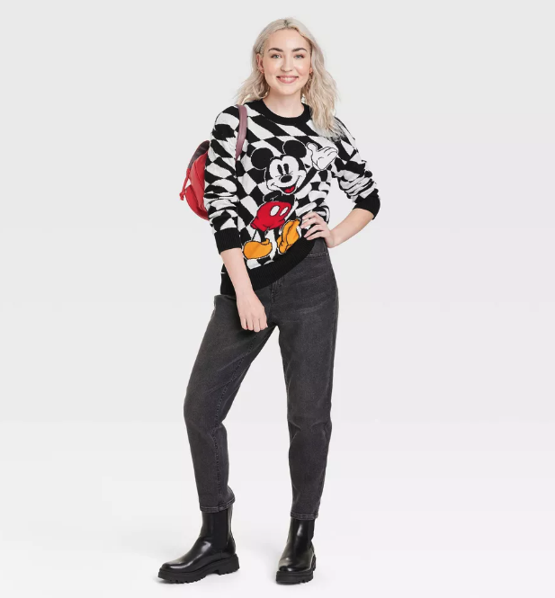 a model in a black and white checkered sweater with mickey mouse on it