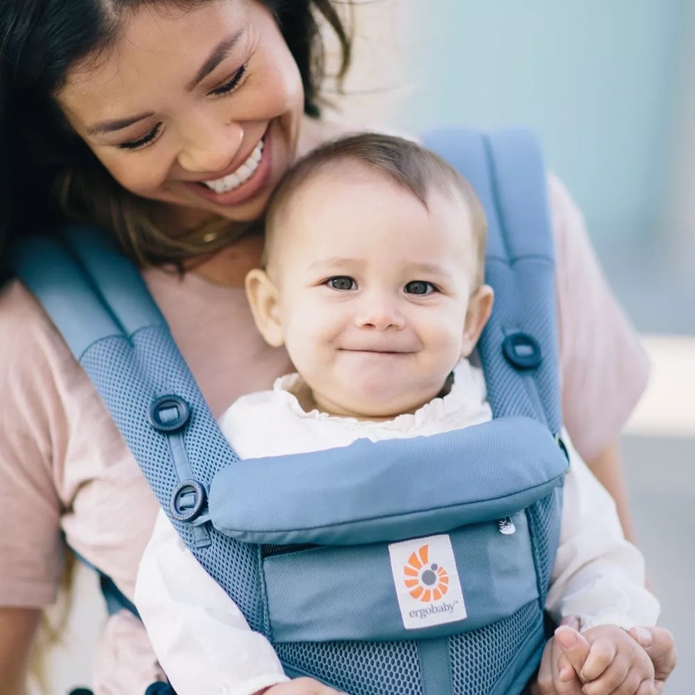 a person wears a very cute baby in the Ergobaby360