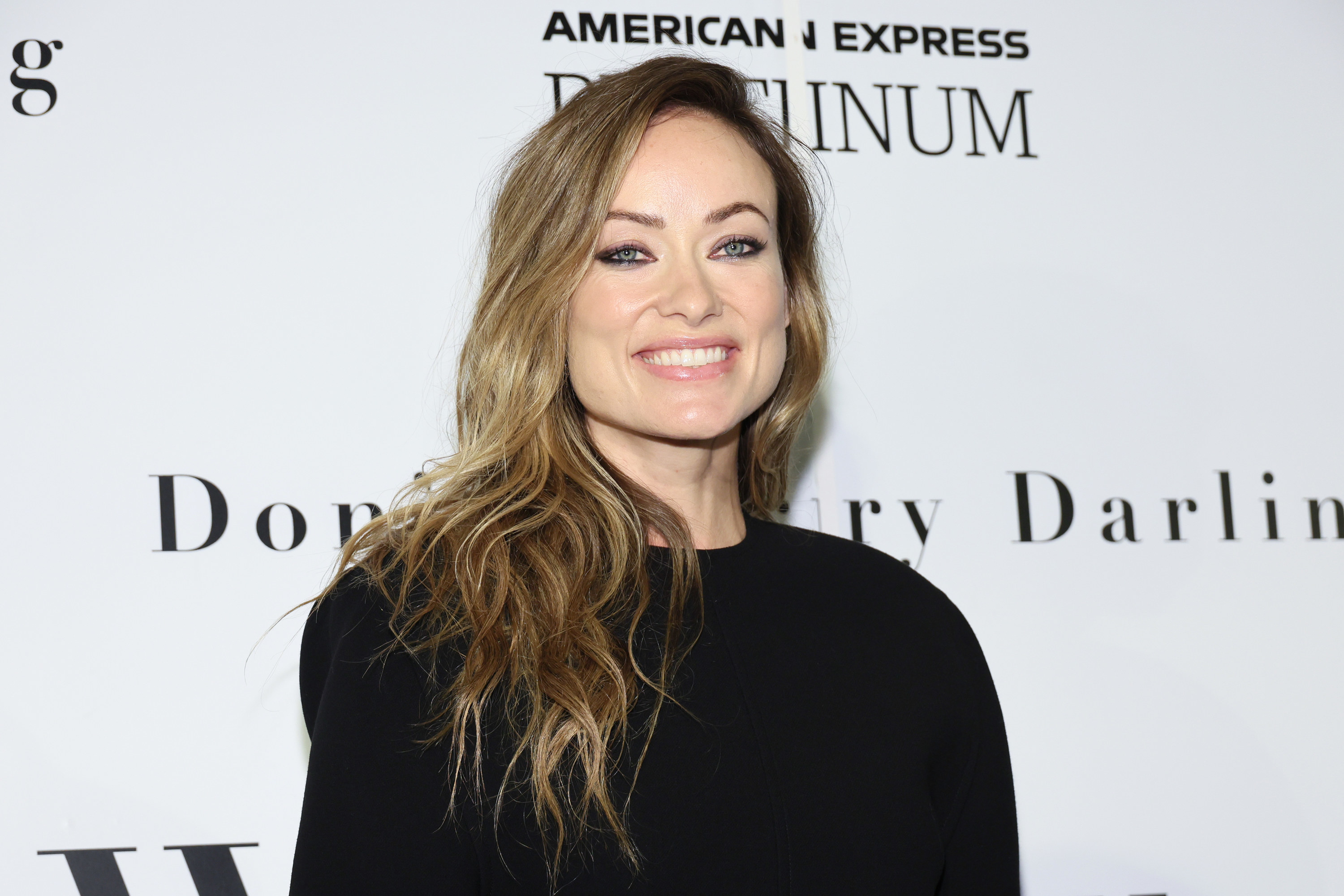 olivia wilde smiling on a red carpet