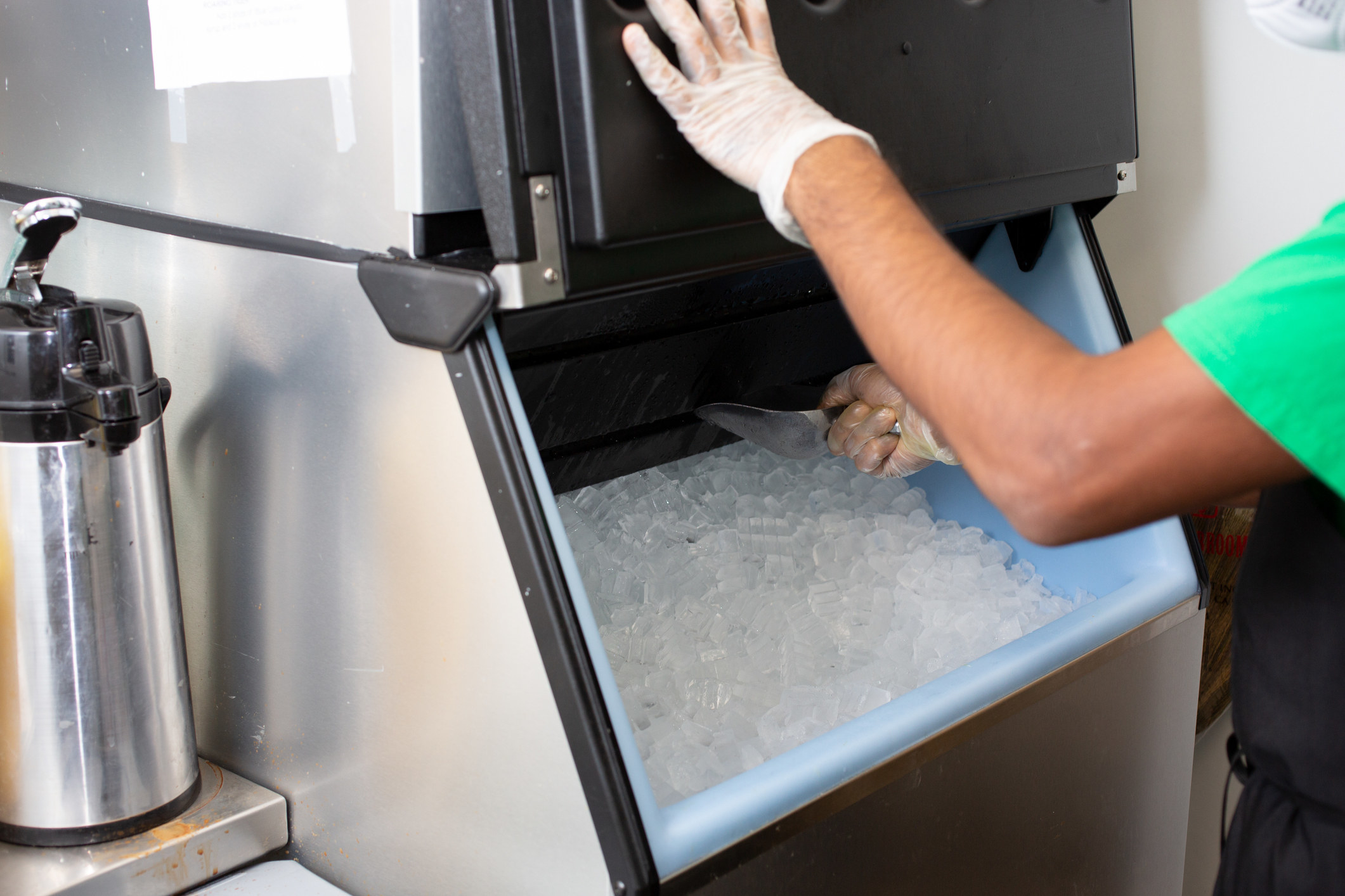 A person scooping ice.