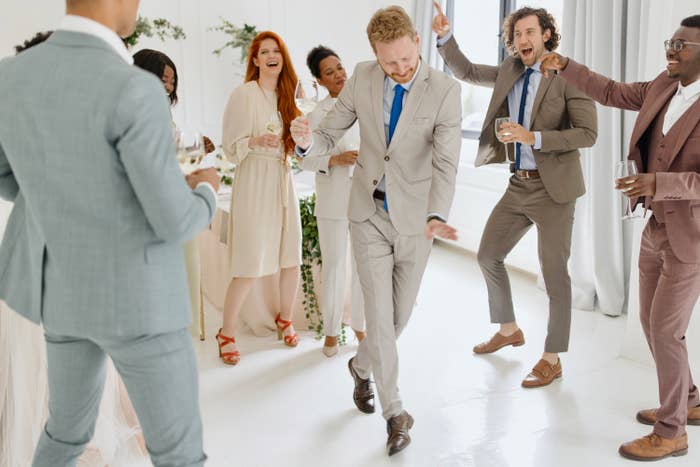 people dancing on a dance floor at a wedding