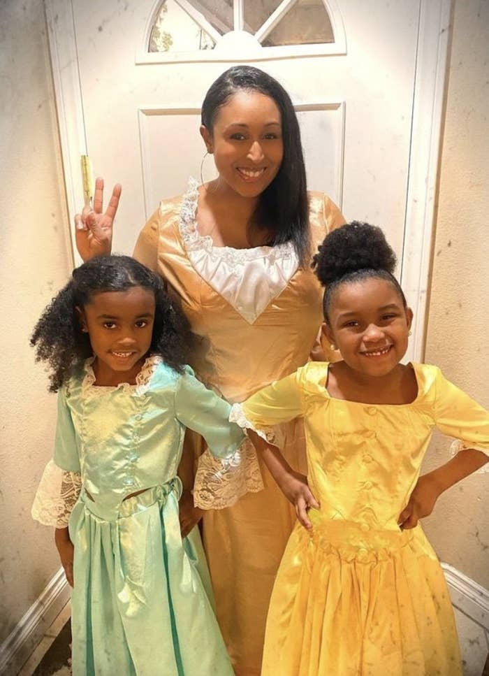 the author and her two daughters in dresses for Hamilton characters