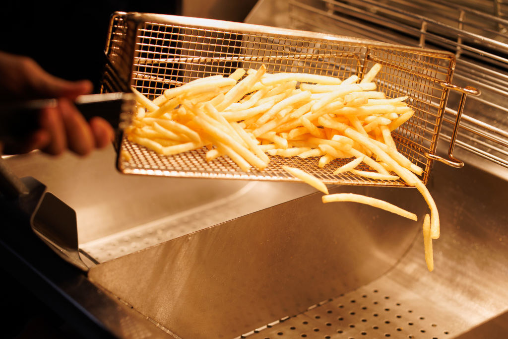 French Fries coming out of the frying basket.