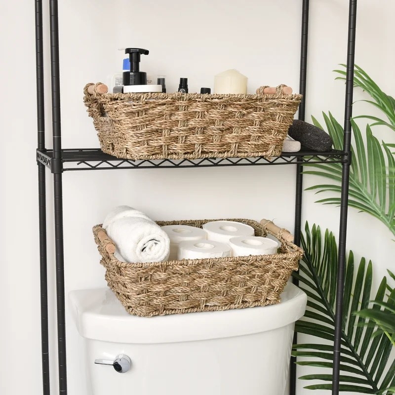 Two storage baskets with handles holding towels and a variety of other items