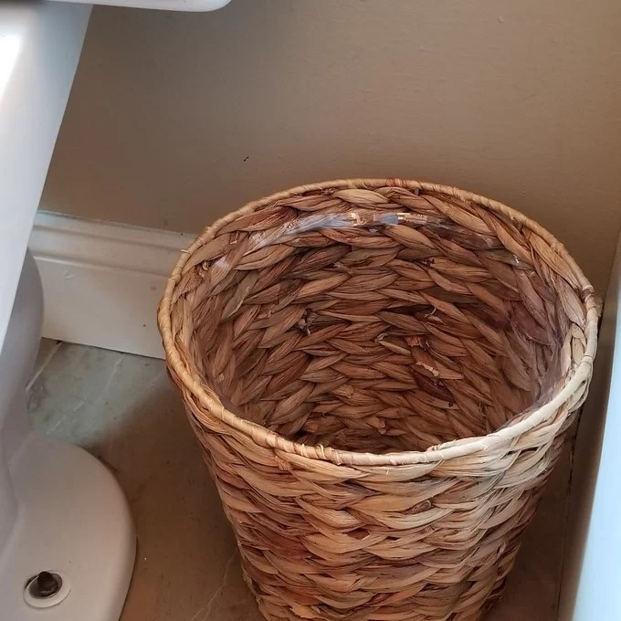 A wicker waste basket