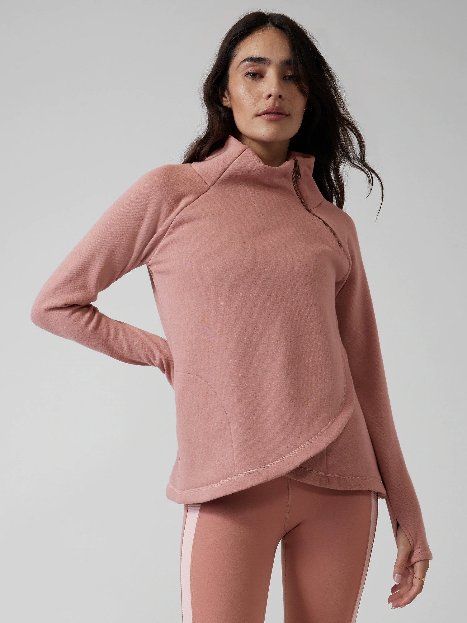 Model in the pink hoodie with thumbholes