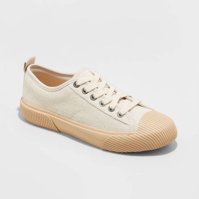 an off-white sneaker with a tan sole