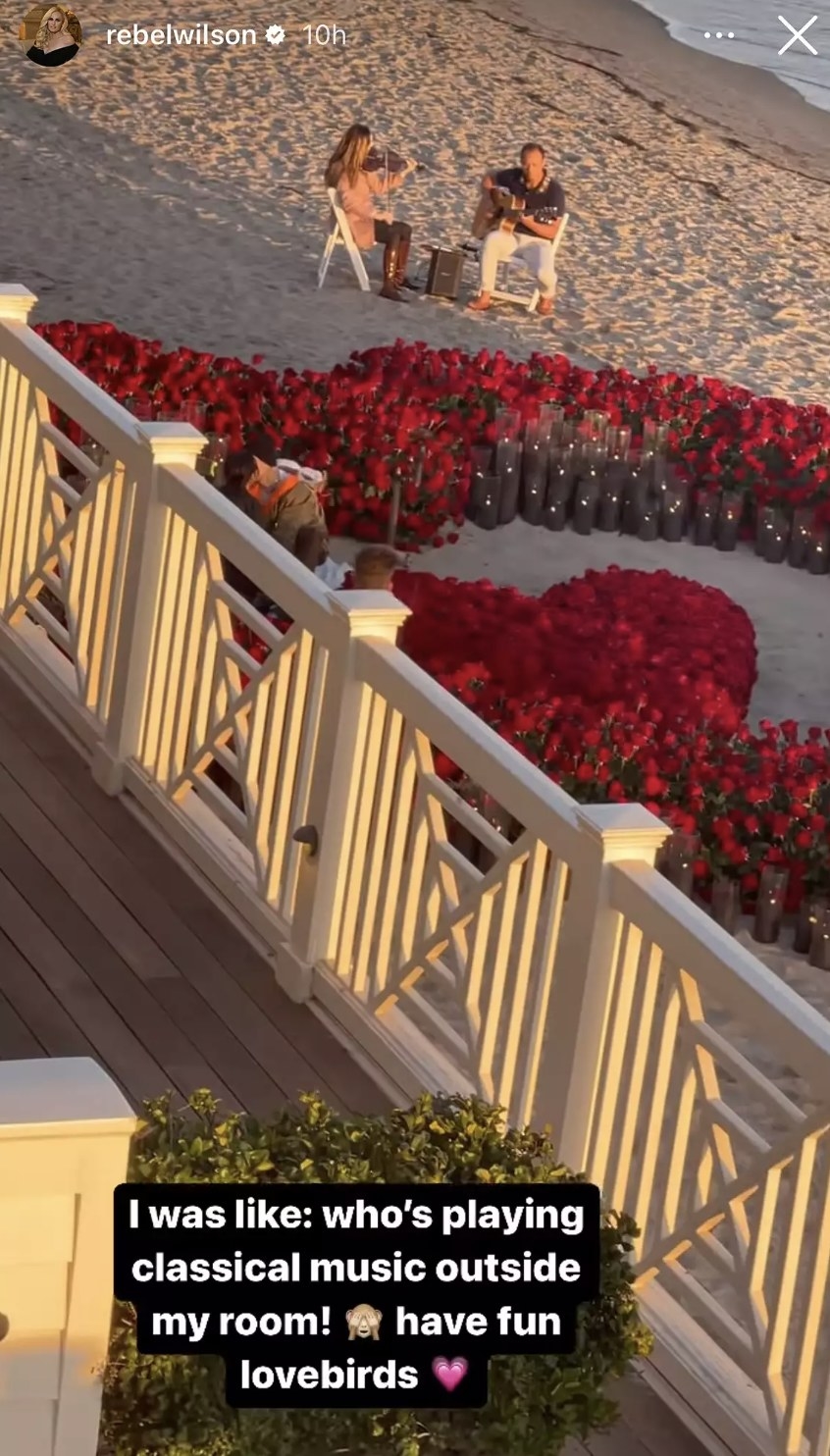 Kourt and Travis can be seen kissing while standing in the middle of a heart made of roses and candles on the beach