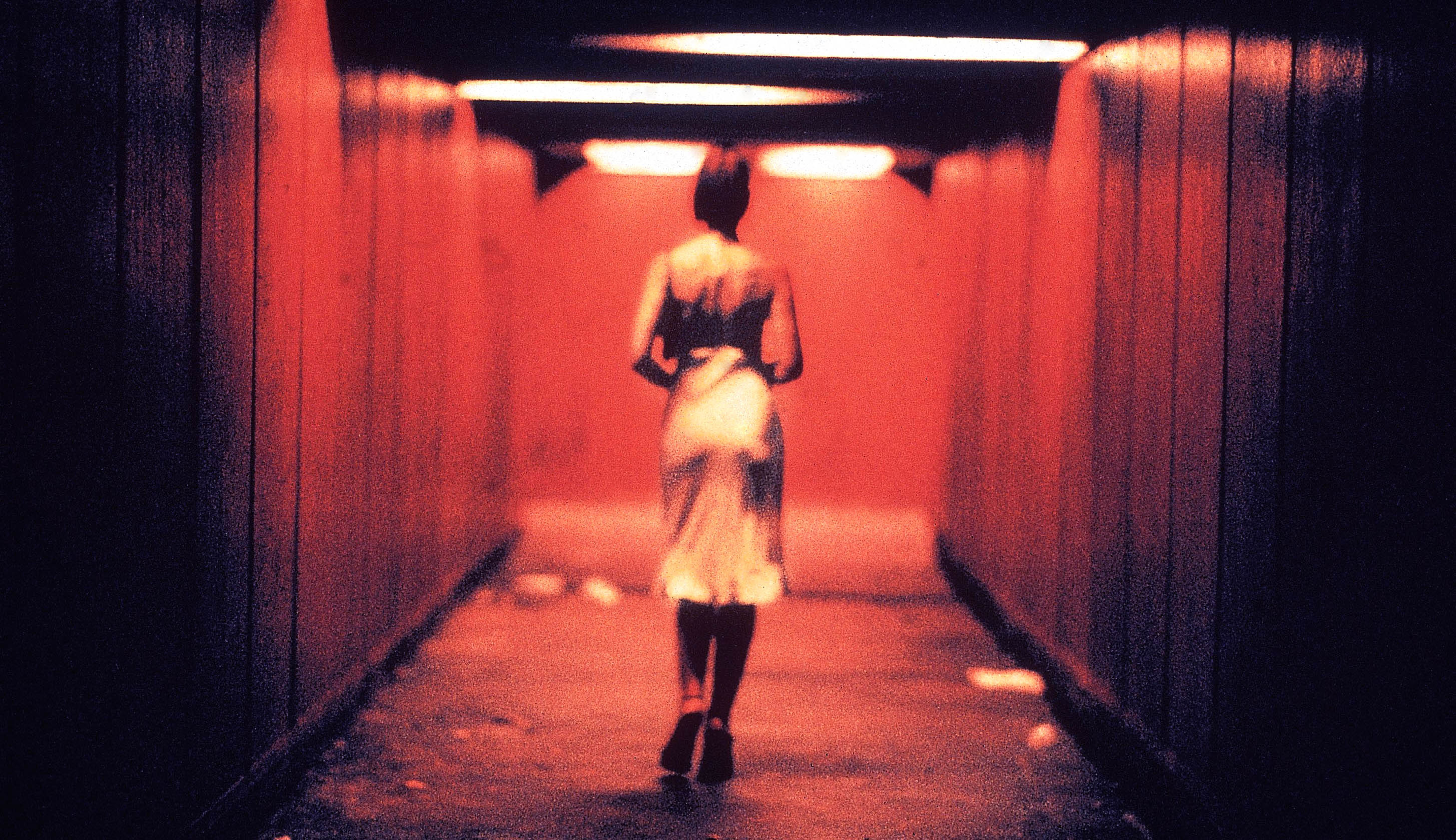 A woman walks down an alleyway alone