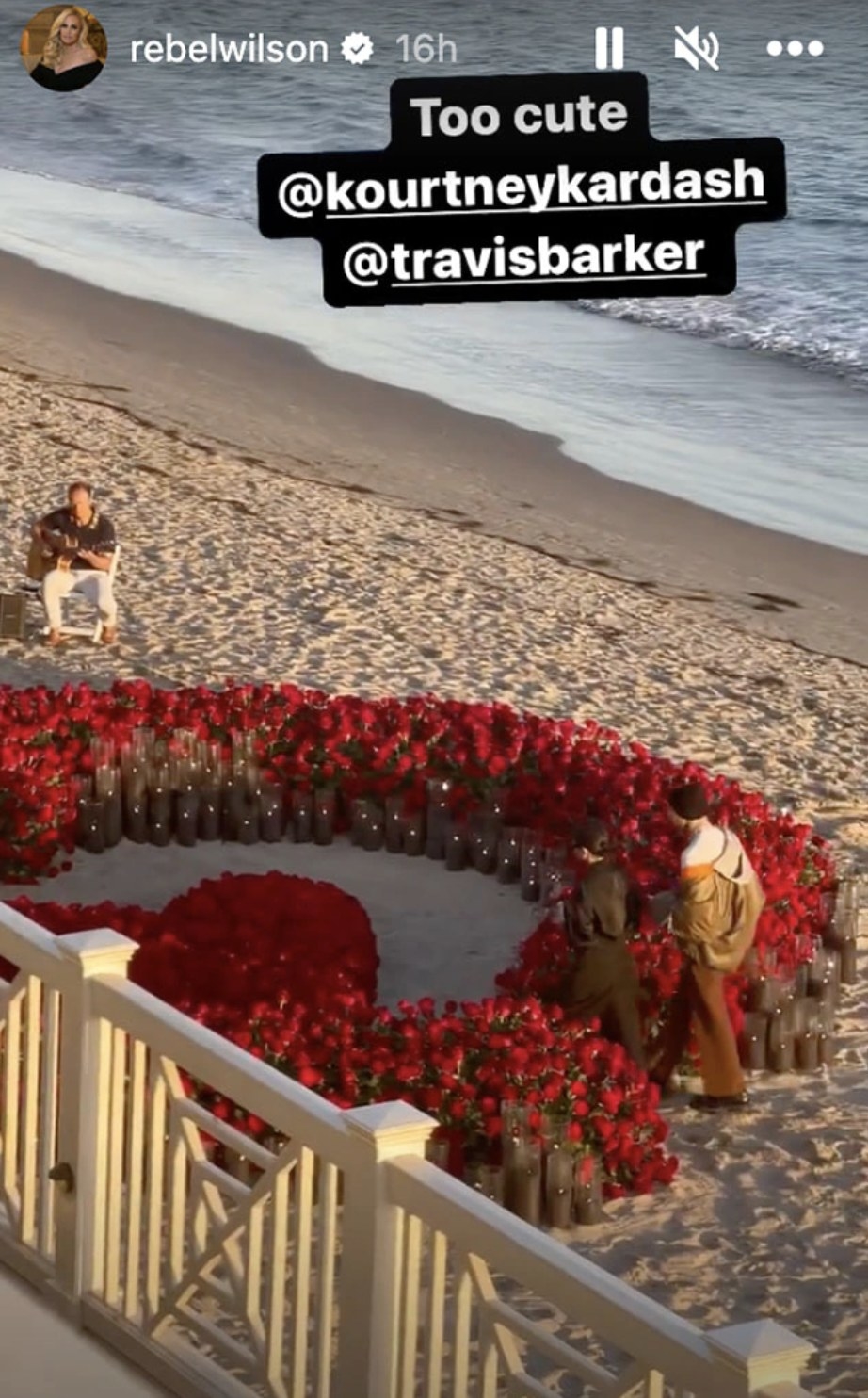 Kourt and Travis can be seen walking towards a heart made of roses and candles on the beach