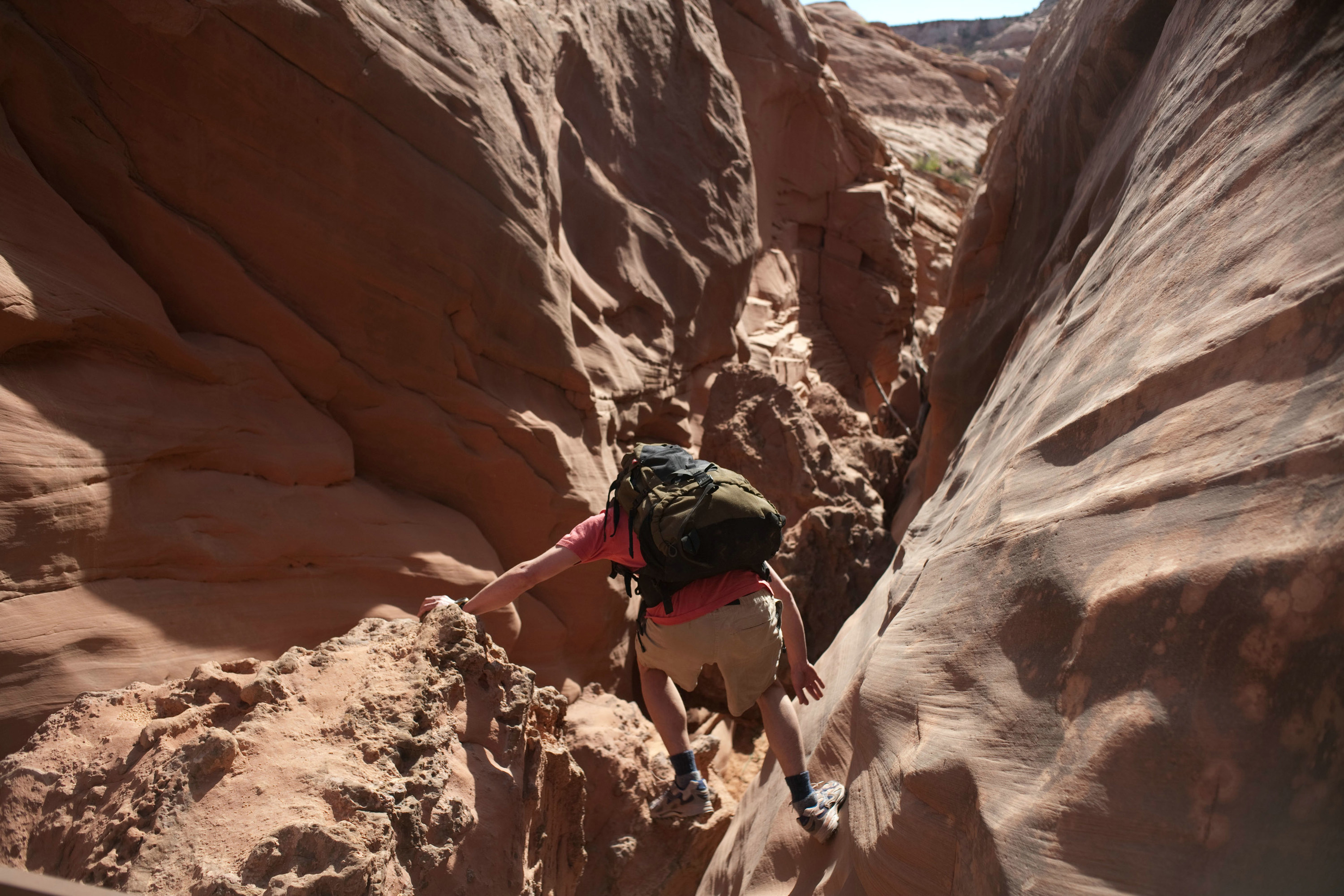 A man climbs through a canyon