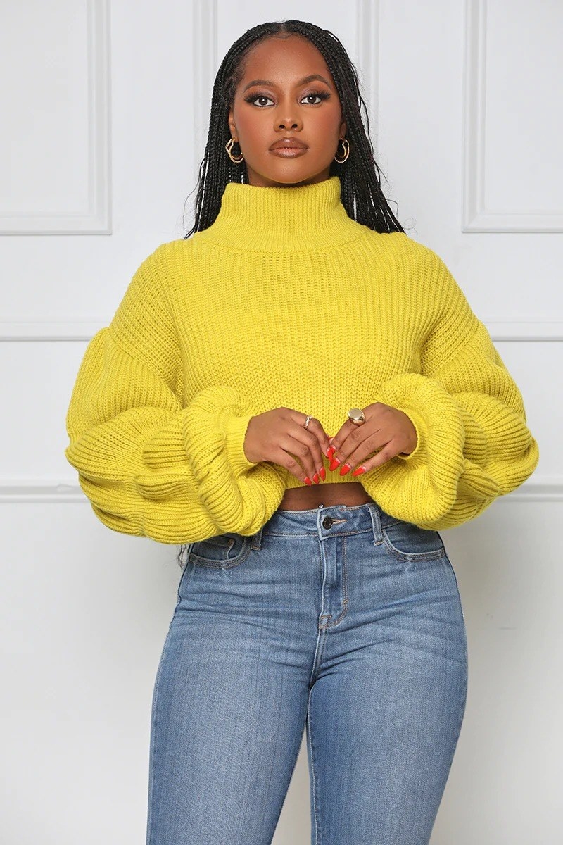 model in a cropped yellow cable knit sweater