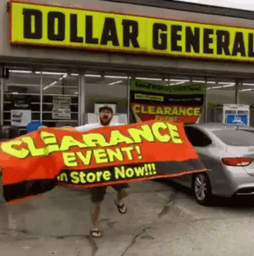 A man dancing and holding a Clearance Event! sign