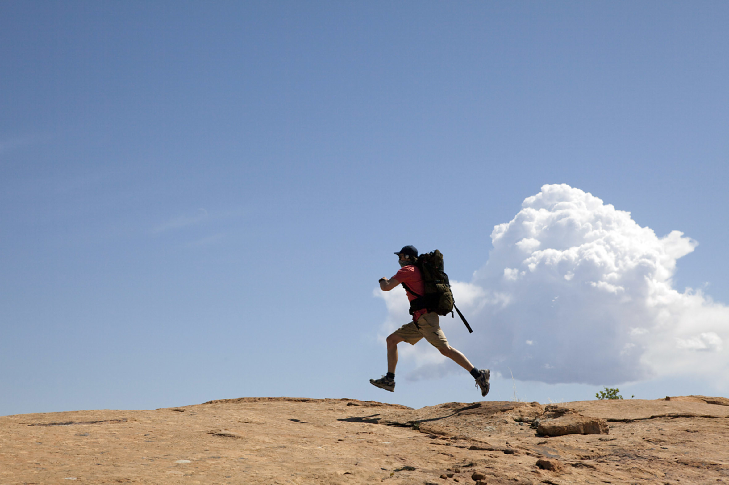 A man running across a canyon