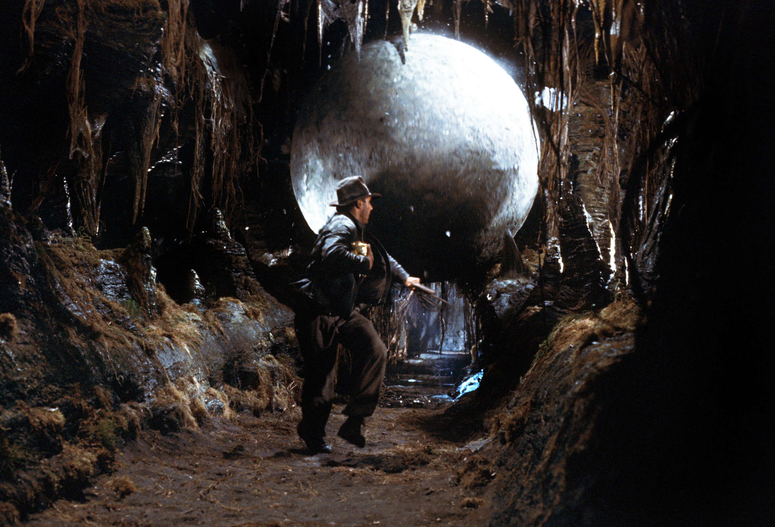 Indiana Jones running away from a huge boulder