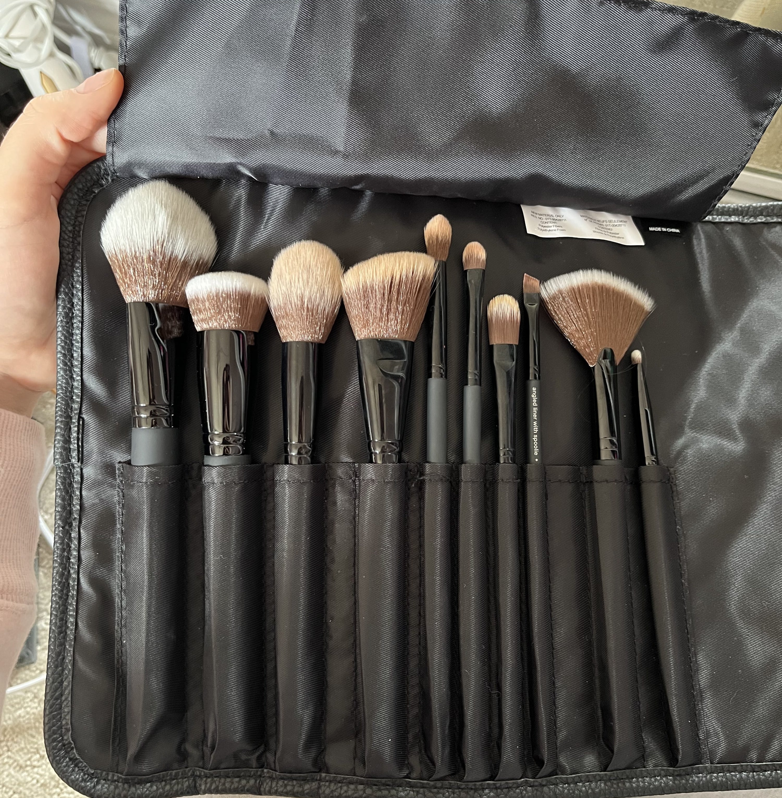 the brush set open displaying the brushes in the leather case