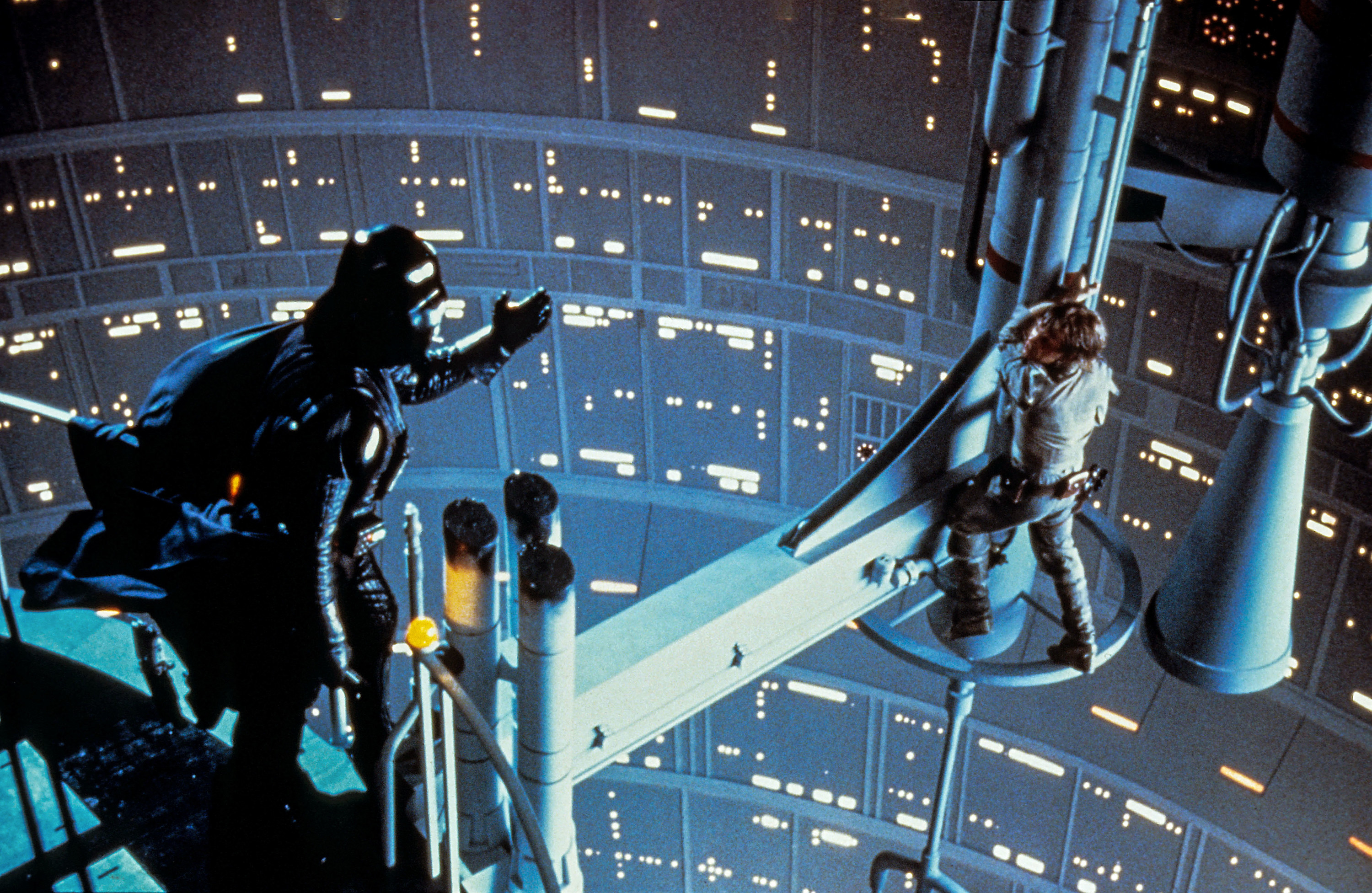 Darth Vader and Luke Skywalker looking across at each other on scaffolding