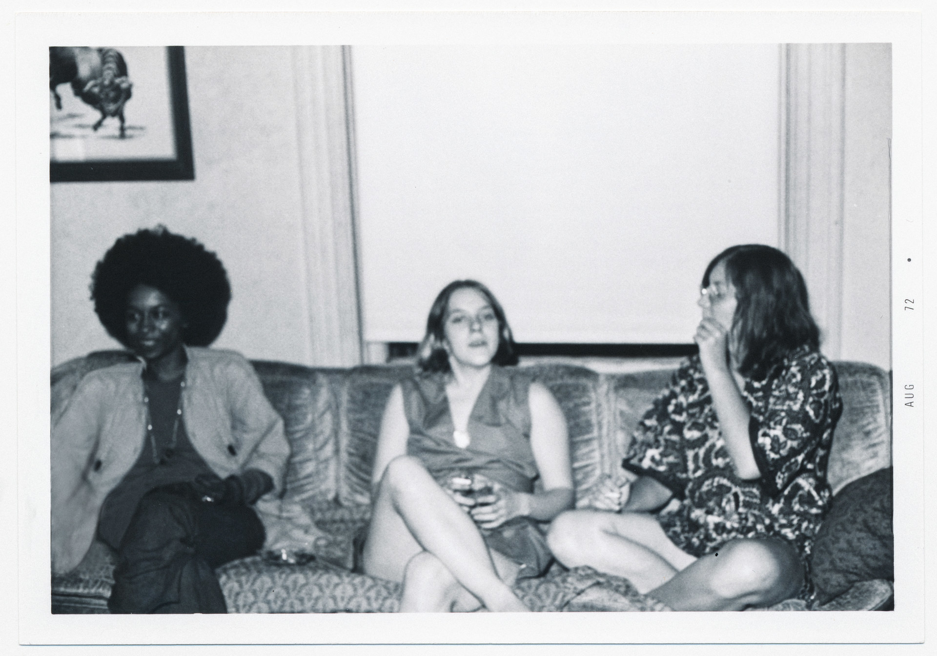Three women sit on a couch