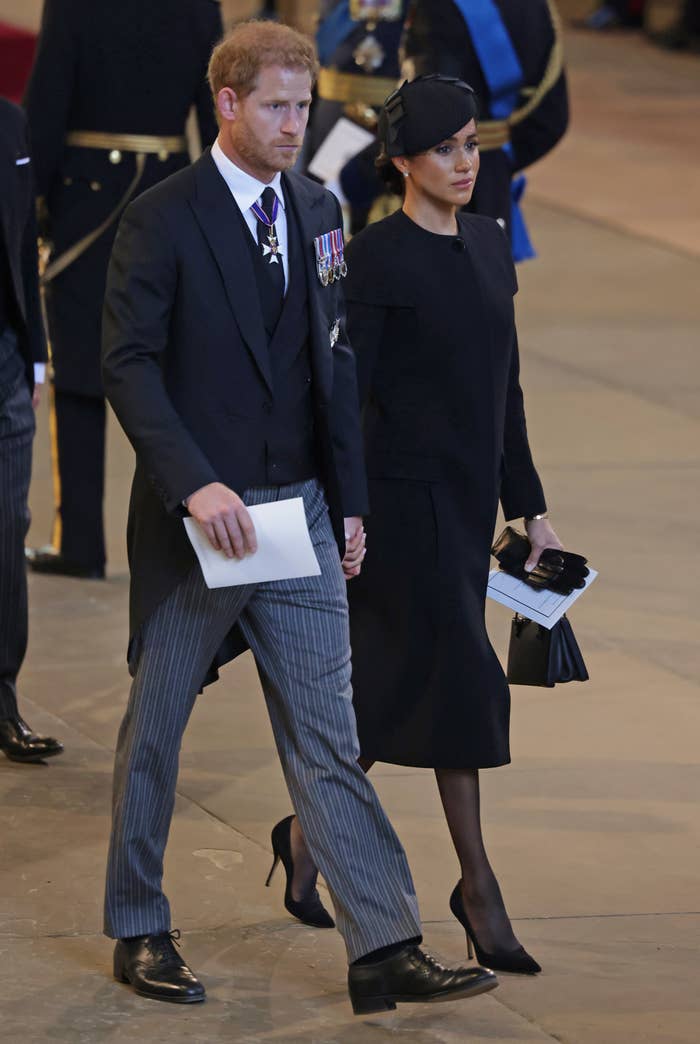 The couple walking hand-in-hand during a royal event