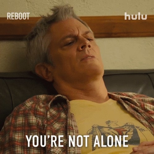 Person sitting in bed looking miserable with caption &quot;You&#x27;re not alone&quot;