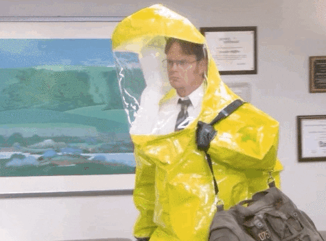 character in a hazmat suit walking into an office
