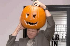 Man shoving a pumpkin on his head